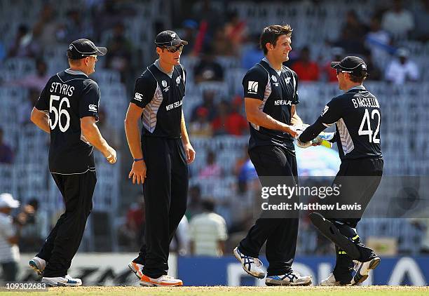 Hamish Bennett of New Zealand is congratulated by team mates after bowling Steve Tikolo of Kenya during the 2011 ICC World Cup Group A match between...