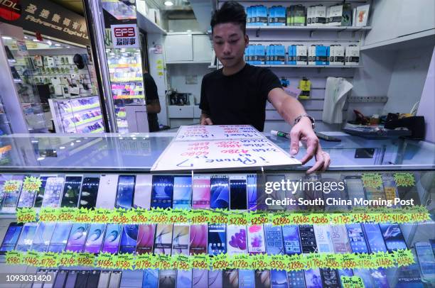 Photos of older versions of iPhones price drops as Apple launches the new iPhone 8 and iPhone X for preorder at a shop in Sin Tat Plaza in Mong Kok....