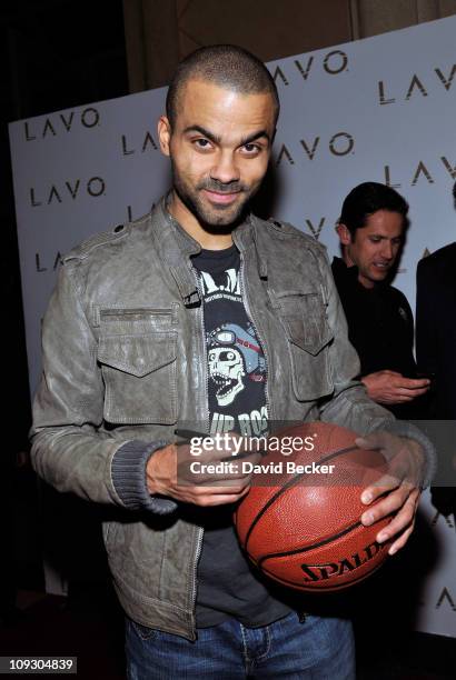Player Tony Parker autographs a basketball after he arrived at the Baller's Ball at the Lavo Nightclub at The Palazzo on February 19, 2011 in Las...