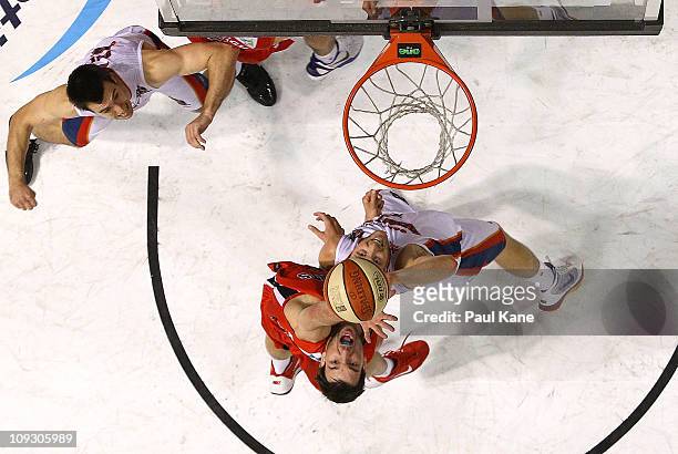 Jeremiah Trueman of the Wildcats and Jacob Holmes of the 36ers contest a rebound during the round 19 NBL match between the Perth Wildcats and the...