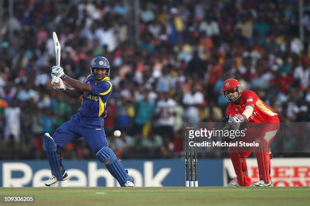 Kumar Sangakkara of Sri Lanka hits to the offside as wicketkeeper Ashish Bagai looks on during the Sri Lanka v Canada 2011 ICC World Cup Group A...