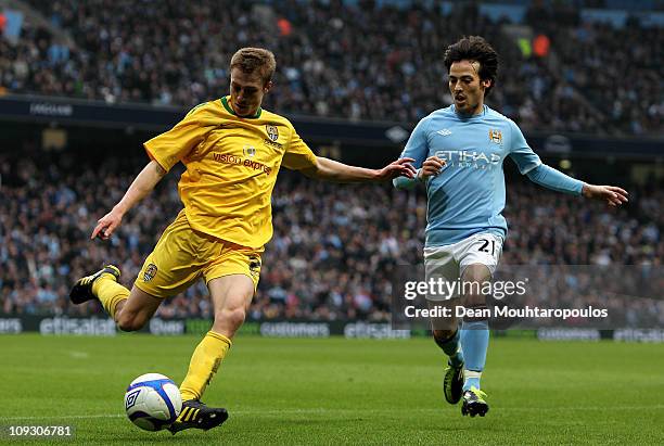 David Silva of Manchester City fights for the ball with Stephen Darby of Notts County during the FA Cup sponsored by E.On 4th Round replay match...