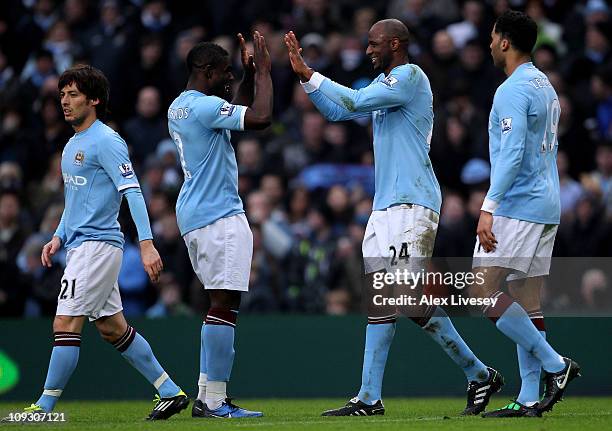 Micah Richards of Manchester City congratulates Patrick Vieira on scoring their second goal during the FA Cup sponsored by E.On 4th Round replay...