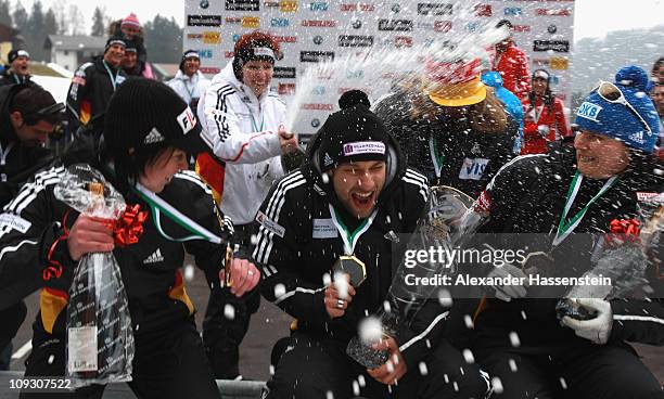 Skeleton athlete Anja Huber of team Germany 1 celebrates with champagne after the medal ceremony of the winning team Germany 2 with Marion Thees ,...
