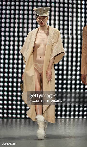 Model walks the runway at the Charlie Le Mindu show during London Fashion Week Autumn/Winter 2011 at Mercer Studios on February 20, 2011 in London,...