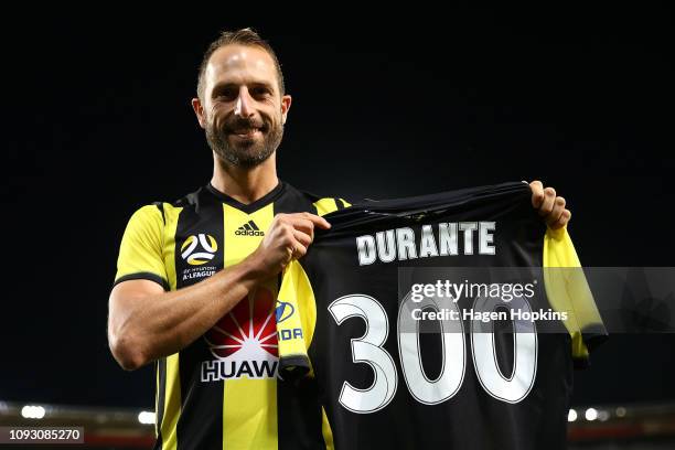 Andrew Durante of the Phoenix holds a commemorative jersey to mark his 300th game during the round 13 A-League match between the Wellington Phoenix...