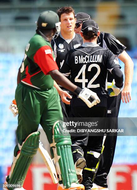 Teammates congratulate New Zealand's Hamish Bennett for taking the wicket of Kenya's batsman Steve Tikolo during the second match in the World Cup...