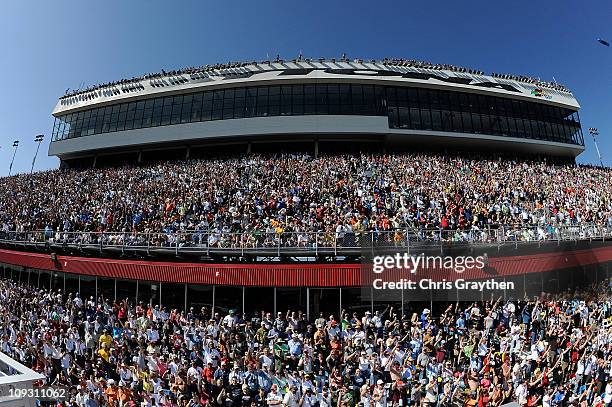 Fans hold up three fingers during lap three, a lap of silence, in honor of Dale Earnhardt, who died on the final lap of the 2001 Daytona 500, during...