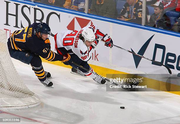 Tyler Myers of the Buffalo Sabres defends against Marcus Johansson of the Washington Capitals at HSBC Arena on February 20, 2011 in Buffalo, New York.