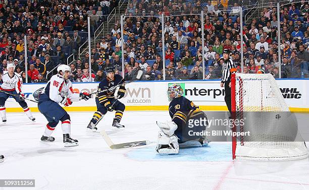 Mathieu Perreault of the Washington Capitals scores a second period goal against Ryan Miller of the Buffalo Sabres at HSBC Arena on February 20, 2011...