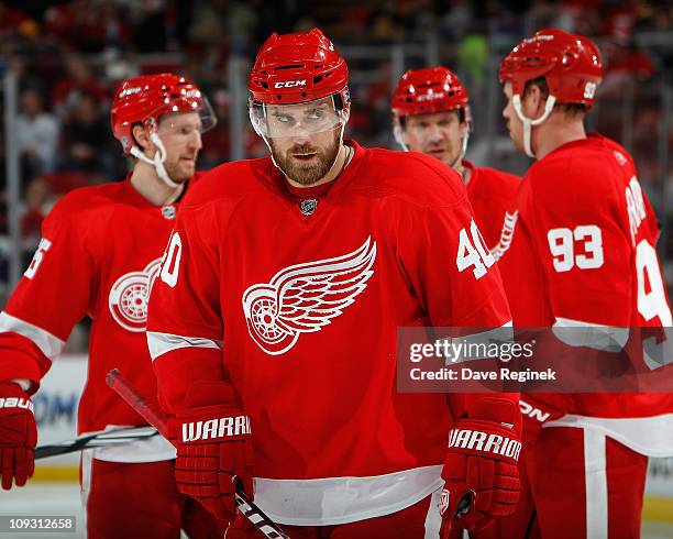 Henrik Zetterberg of the Detroit Red Wings looks to the side in front of teammates Nicklas Kronwall, Nicklas Lidstrom and Johan Franzen during an NHL...