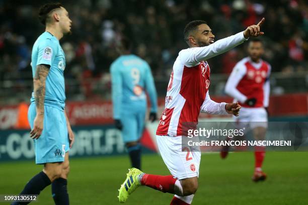 Reims' French defender Tristan Dingome celebrates after scoring during the French L1 football match between Stade de Reims and Olympique de Marseille...