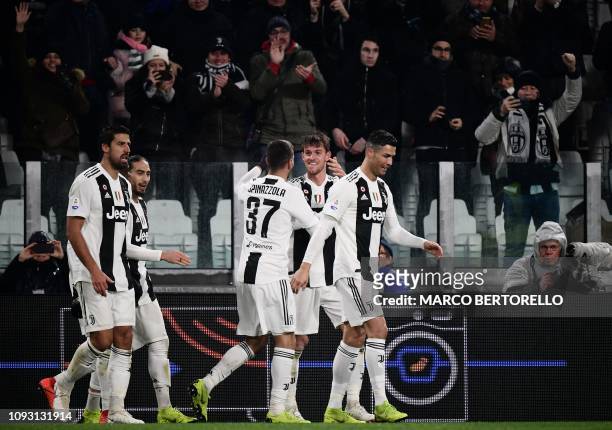 Juventus' Italian defender Daniele Rugani celebrates with Parma's Italian midfielder Matteo Scozzarella after scoring during the Italian Serie A...