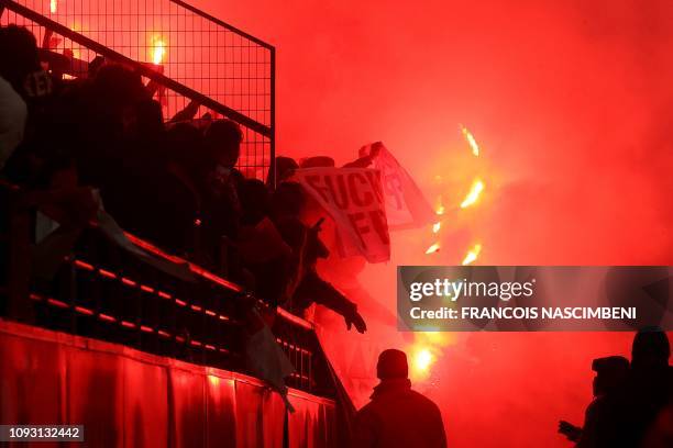 Marseille's supporters wave flares during the French L1 football match between Stade de Reims and Olympique de Marseille at the Auguste Delaune...