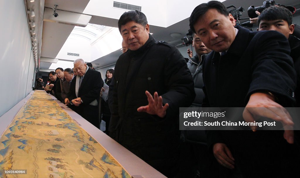 Shan Jixiang (2nd RIGHT), Director of the Palace Museum, Tung Chee Hwa (3rd RIGHT), vice chairman of CPPCC, look at a painting that Hui Wing-mau, chairman of Shimao Group, donates (an ancient Landscape Map of Silk Road) to Palace Museum on Nov. 30, 2017