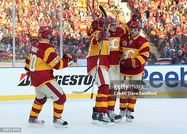 Rene Bourque of the Calgary Flames celebrates with teammates after he scored a first period goal against the Montreal Canadiens during the 2011 NHL...