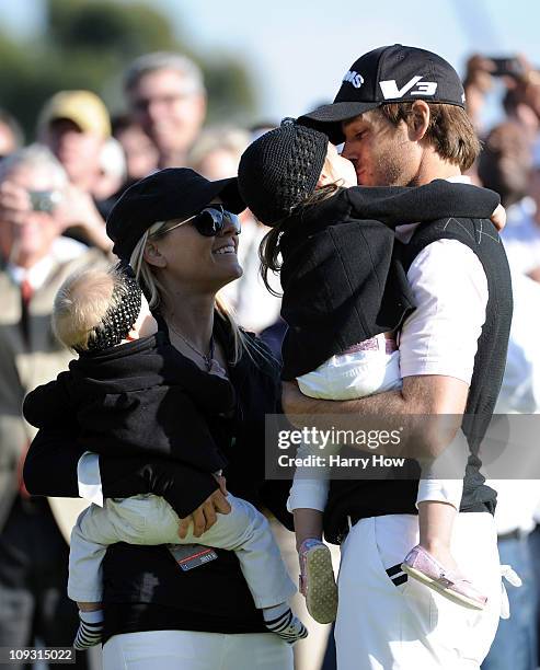 Aaron Baddeley of Australia celebrates his win with daughter Jewell, wife Richelle and daughterJolee on the side of the 18th green during the fourth...