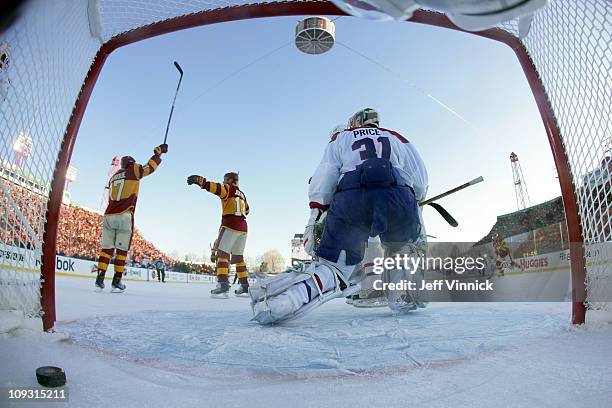 Rene Bourque of the Calgary Flames celebrates his first period goal with teammate Olli Jokinen as goaltender Carey Price of the Montreal Canadiens...