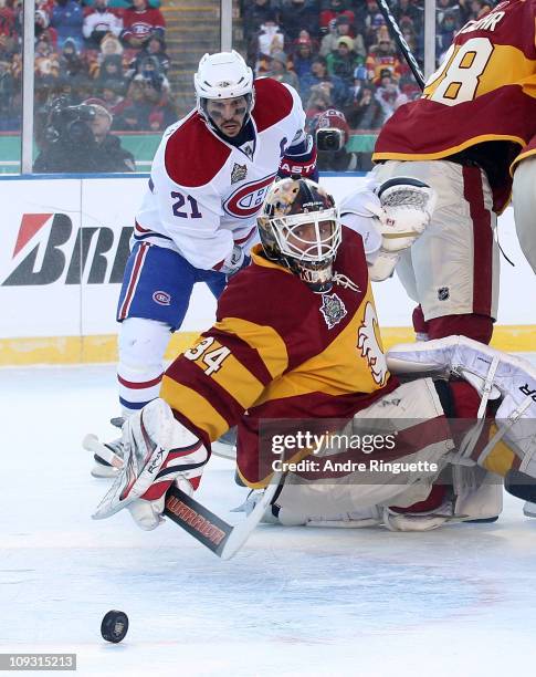 Miikka Kiprusoff of the Calgary Flames makes the save as Brian Gionta of the Montreal Canadiens looks for a rebound during the 2011 NHL Heritage...