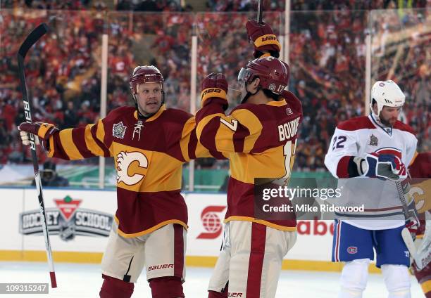 Rene Bourque of the Calgary Flames scores a power play goal at 8:09 of the first period and is joined by Olli Jokinen in first period action against...