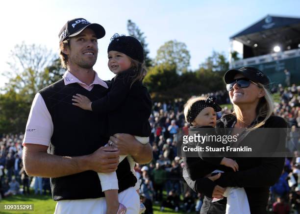 Aaron Baddeley of Australia is congratulated by his wife Richelle Baddeley and children Jewell and Jolee after the final round of the Northern Trust...