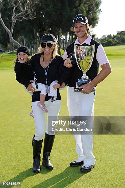 Aaron Baddeley of Australia poses his wife Richelle, daughters Jewel and Jolee and the tournament trophy after winning the Northern Trust Open at...