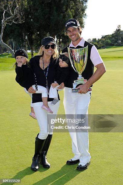 Aaron Baddeley of Australia poses his wife Richelle, daughters Jewel and Jolee and the tournament trophy after winning the Northern Trust Open at...