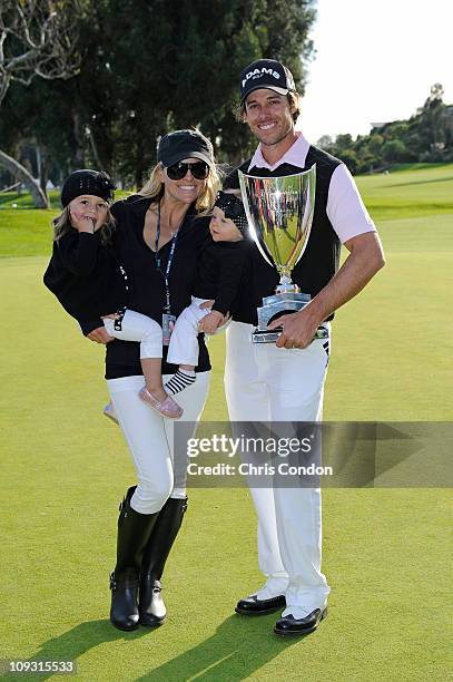 Aaron Baddeley of Australia poses his wife Richelle, daughters Jewel and Jolee and the tournament trophy after winning the Northern Trust Open at...