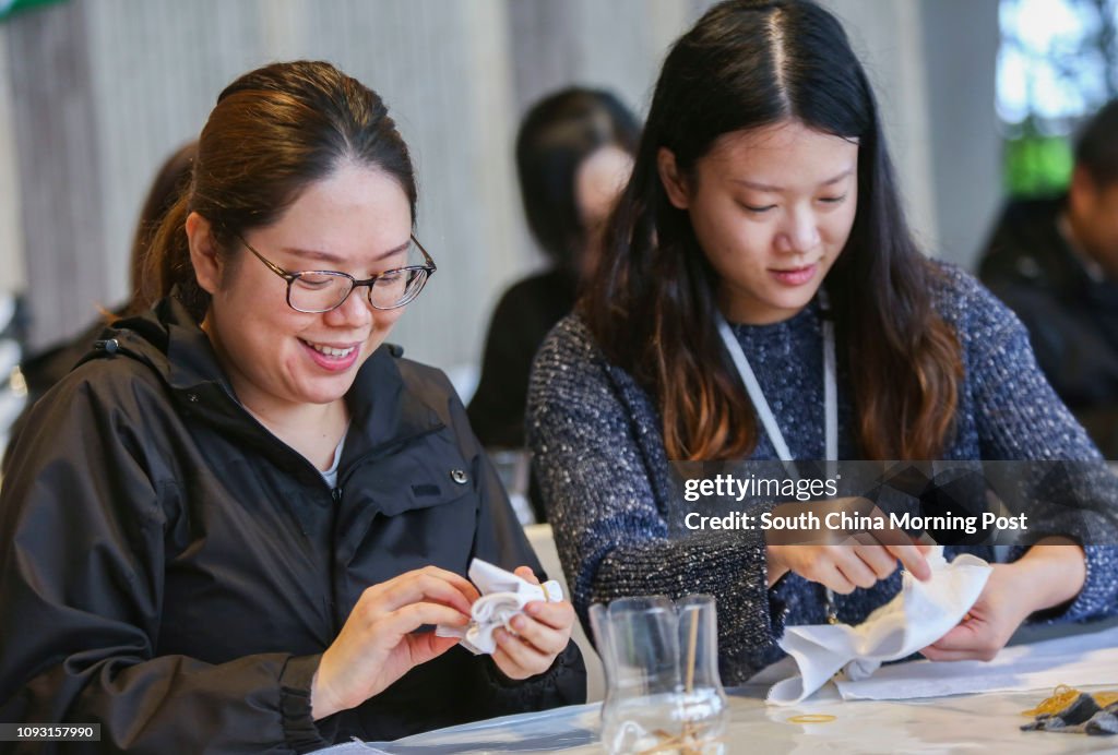 Karina Leung Ka-ki (left) and Camille Wong Lai-ming (right) learn how to dye handkerchiefs to be used as Christmas gift wraps during an OpSanta (the annual Operation Santa Claus charity campaign) event in Maxims in Cheung Sha Wan. 13DEC17 SCMP / Xiaomei C