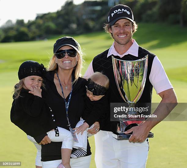 Aaron Baddeley of Australia poses his wife Richelle, daughters Jewel and Jolee and the tournament trophy after winning the final round of the...