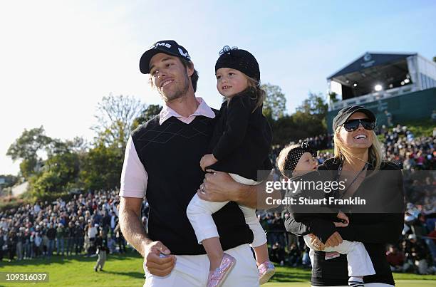 Aaron Baddeley of Australia is congratulated by his wife Richelle Baddeley and children Jewell and Jolee after the final round of the Northern Trust...