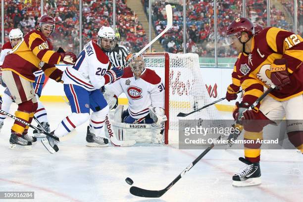 James Wisniewski and Carey Price of the Montreal Canadiens defend against Jarome Iginla and Alex Tanguay of the Calgary Flames during the 2011...
