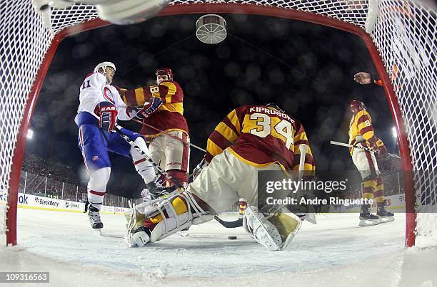 Robyn Regehr and goaltender Miikka Kiprusoff of the Calgary Flames combine to stop Scott Gomez of the Montreal Canadiens during the 2011 NHL Heritage...