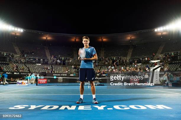 Alex De Minaur of Australia poses with his trophy after victory in his Mens Final match against Andreas Seppi of Italy during day seven of the 2019...