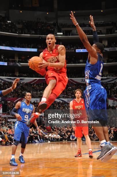 Russell Westbrook of the Western Conference All-Stars goes up for a shot against Joe Johnson of the Eastern Conference All-Stars in the 2011 NBA...