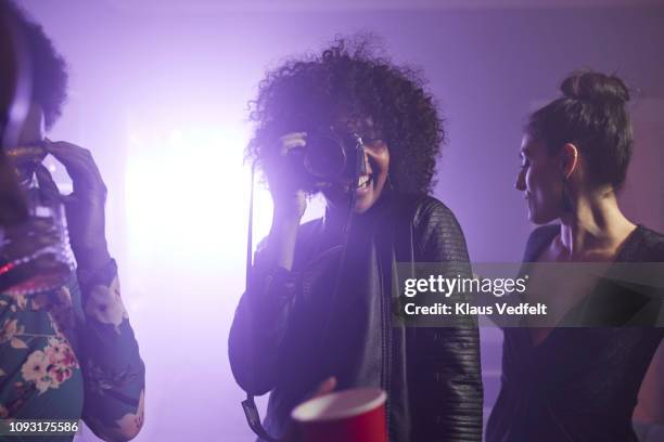 young woman photographing her friends dancing - black photographer stock pictures, royalty-free photos & images