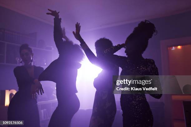 young women dancing and cheering at home party - house after party stock pictures, royalty-free photos & images