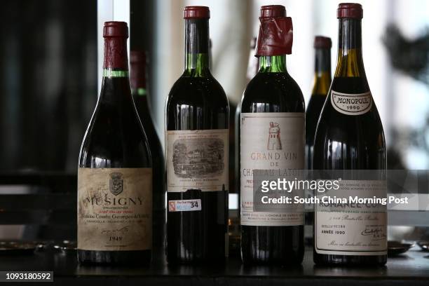 Bottles of fake wine Musigny, Cuvee Vielles Vignes, Domaine Comte Georges de Vogue, Chambolle-Muscigny 1949, and Chateau Lafite-Rothschild 1961 and...