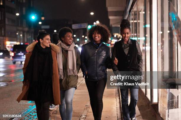 young women walking on city street a night - midnight stock pictures, royalty-free photos & images