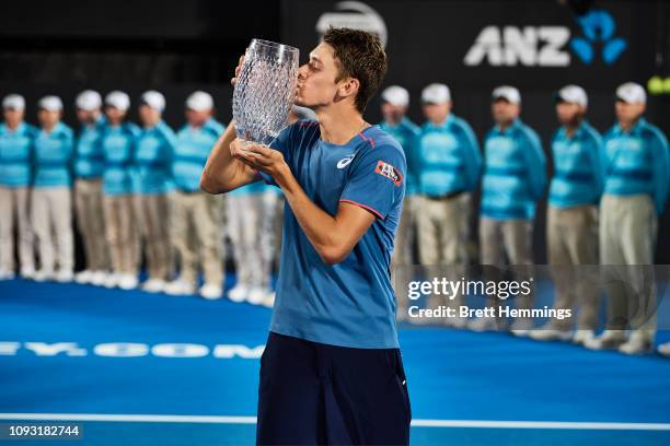 Alex De Minaur of Australia poses with his trophy after victory in his Mens Final match against Andreas Seppi of Italy during day seven of the 2019...