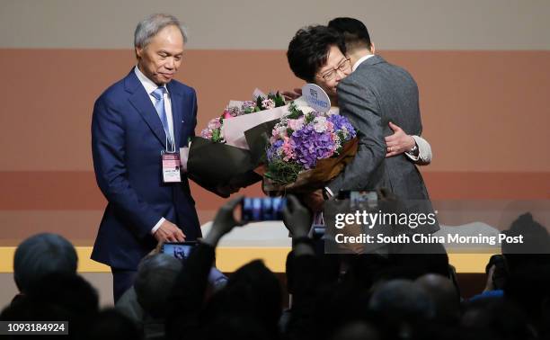 Lam Siu-por looks on as his wife Carrie Lam Cheng Yuet-ngor hugs their son Jeremy Lam Tsit-sze on stage after Carrie Lam won the Hong Kong Chief...