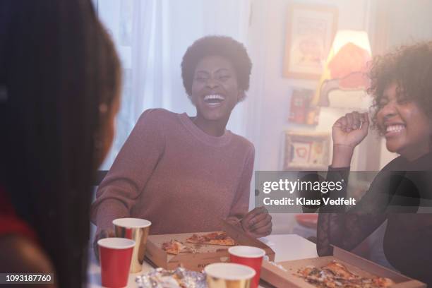 young women having party in the kitchen and eating pizza - luxury home dining table people lifestyle photography people stock pictures, royalty-free photos & images