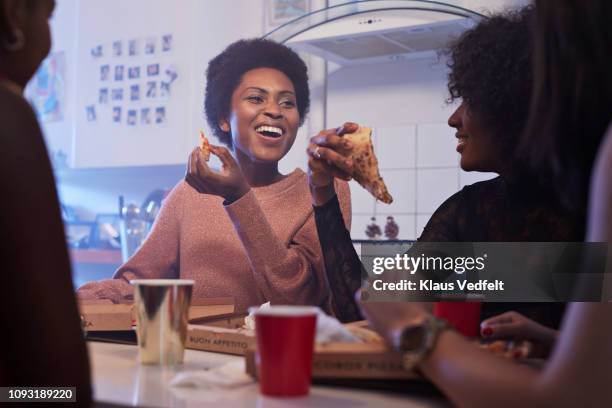 young women having party in the kitchen and eating pizza - woman junk food eating stock pictures, royalty-free photos & images