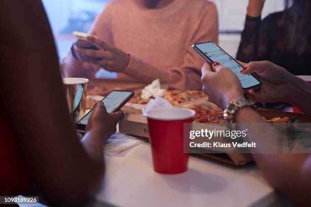 young women having party in the kitchen and looking at phones - red telephone box photos et images de collection