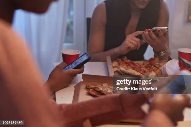 young women having party in the kitchen and looking at phones - red telephone box photos et images de collection