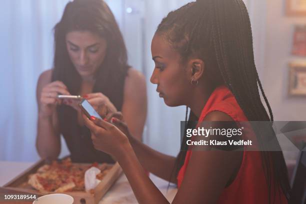young women having party in the kitchen and looking at phones - facebook profile stock pictures, royalty-free photos & images
