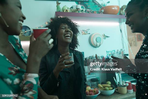 young women laughing and having party in the kitchen - cocktail dress stock-fotos und bilder