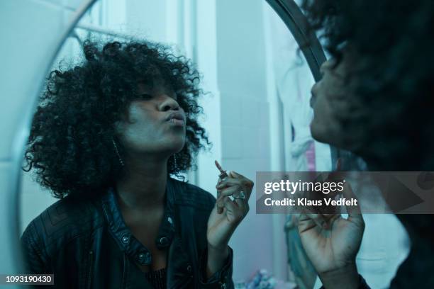 young women doing make-up in the bathroom mirror at pre-party - make up brush stockfoto's en -beelden