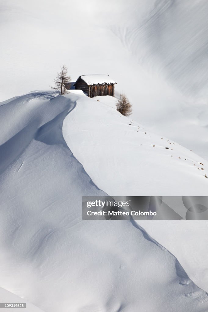 Mountain hut in snow