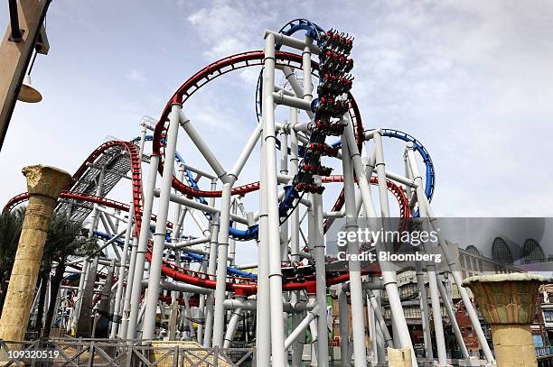 Visitors take a ride on the Battlestar Galactica rollercoaster during its reopening at the Universal Studios Singapore theme park in Genting...